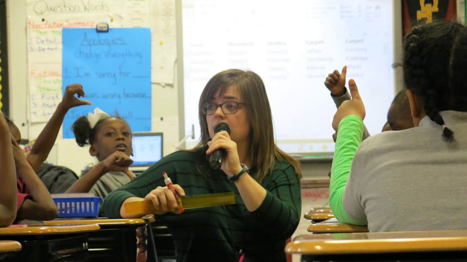 Second-grade teacher Katelyn Woodard uses a wireless microphone and amplifier to project her voice during class on Jan. 13, 2015, at Cornerstone Preparatory School in Memphis.