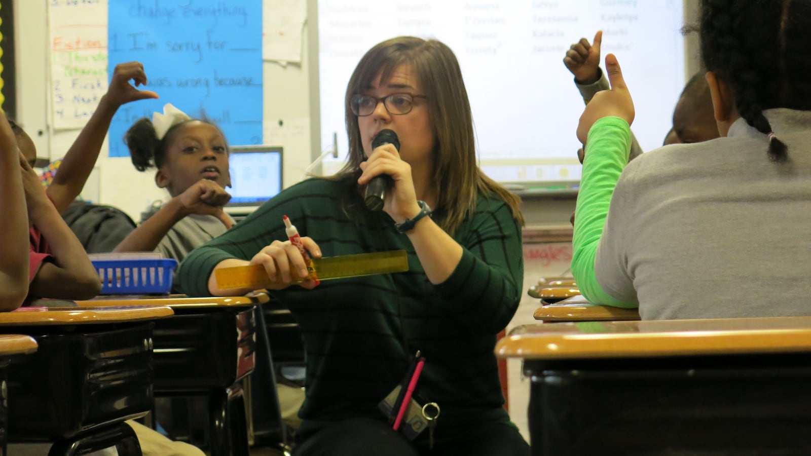 Second-grade teacher Katelyn Woodard uses a wireless microphone and amplifier to project her voice during class on Jan. 13, 2015, at Cornerstone Preparatory School in Memphis.