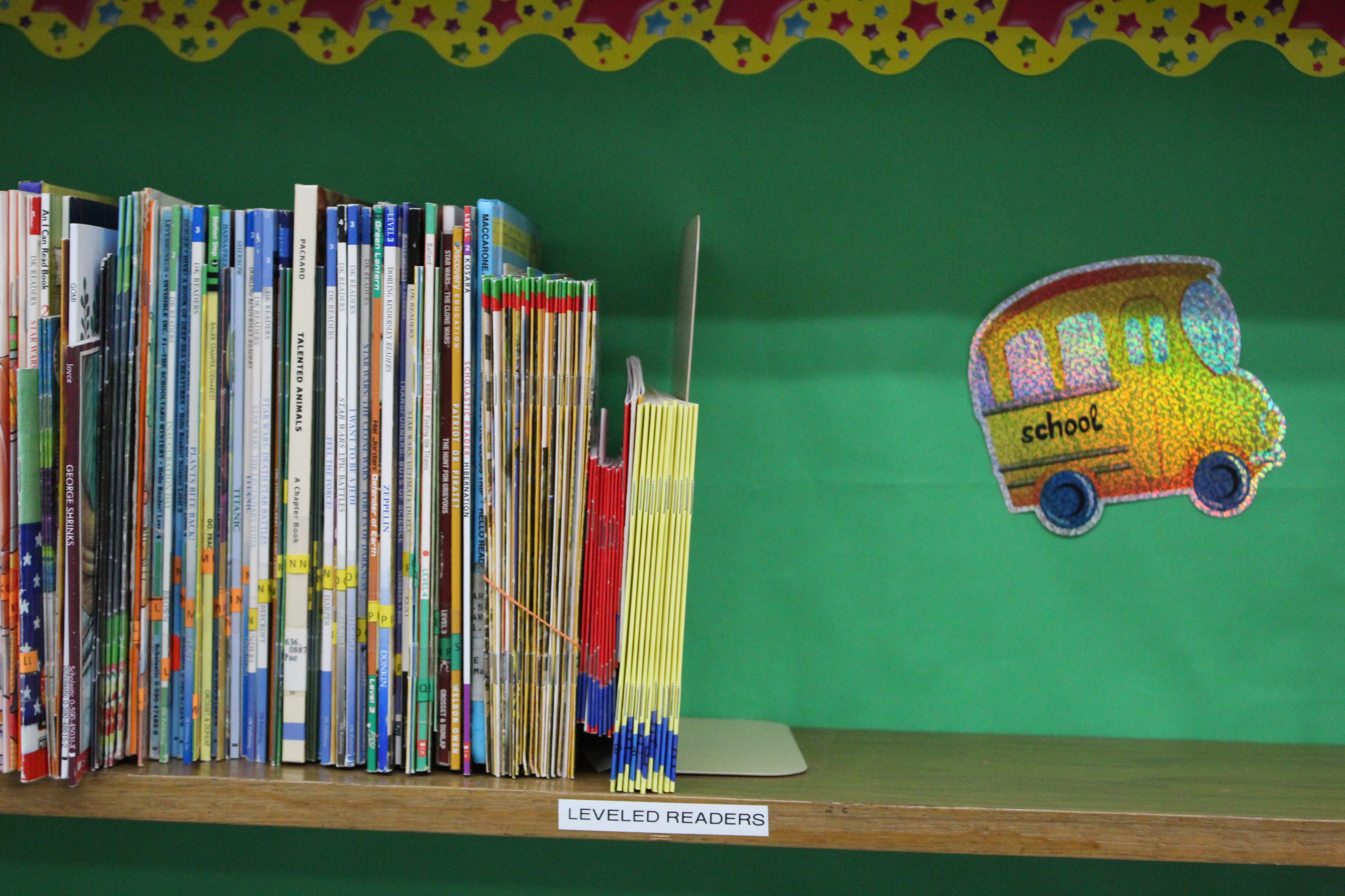 Books on a shelf in a classroom