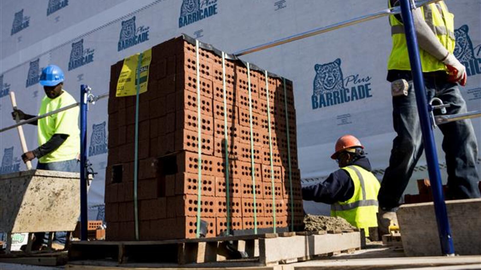 Bricklayers from TopCat Masonry Contractors LLC work on an apartment complex in downtown Memphis in 2014.
