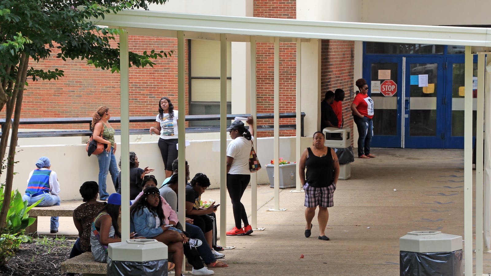 Parents stand outside of Ridgeway High School on Wednesday, June 3, 2015. Long lines piled up for summer school registration.