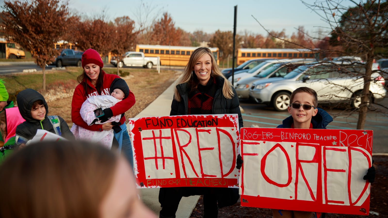 Teacher supporters demonstrate with signs during a Red for Ed protest.