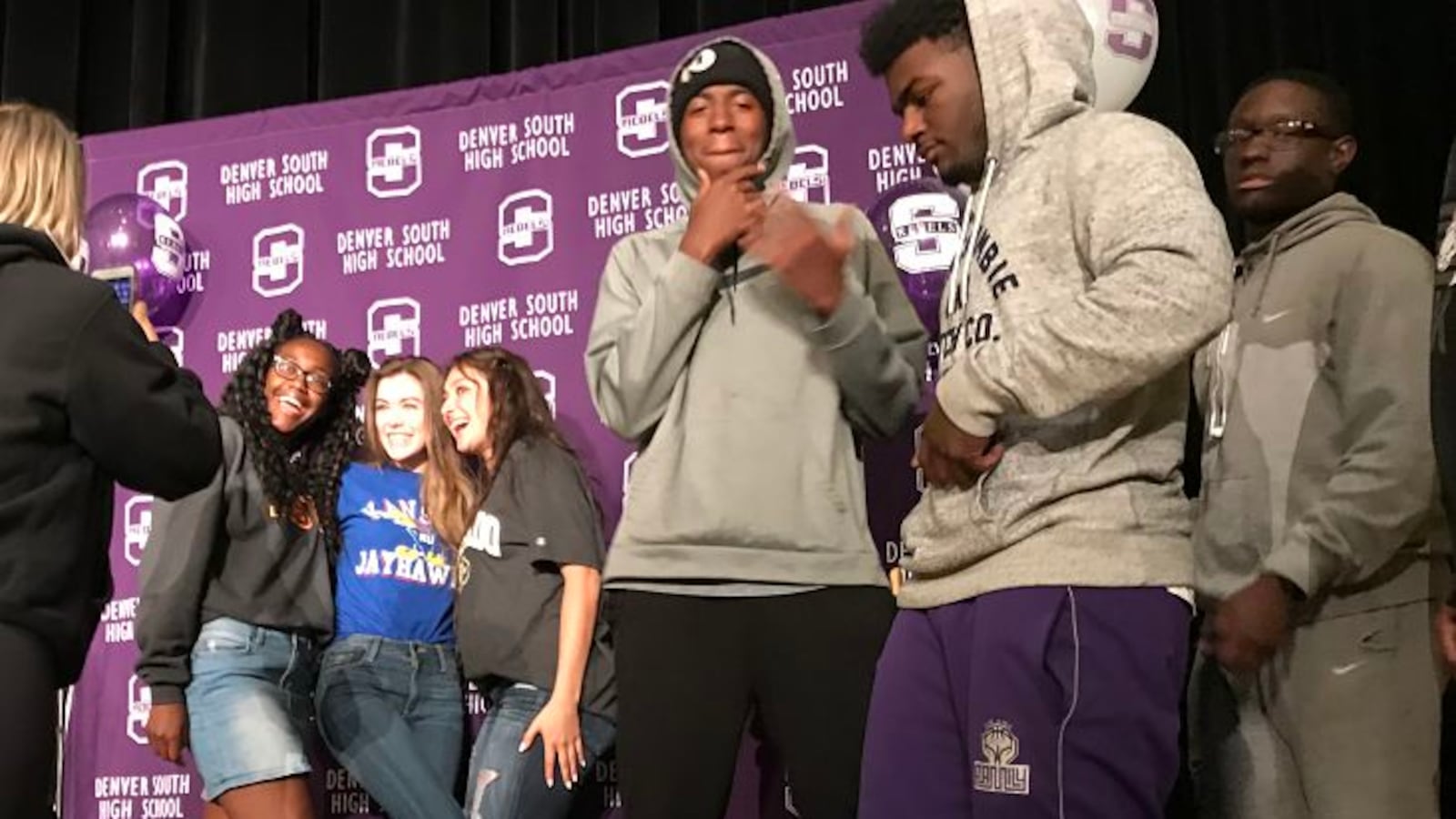 Seniors at Denver's South High School pose after an assembly about college enrollment.