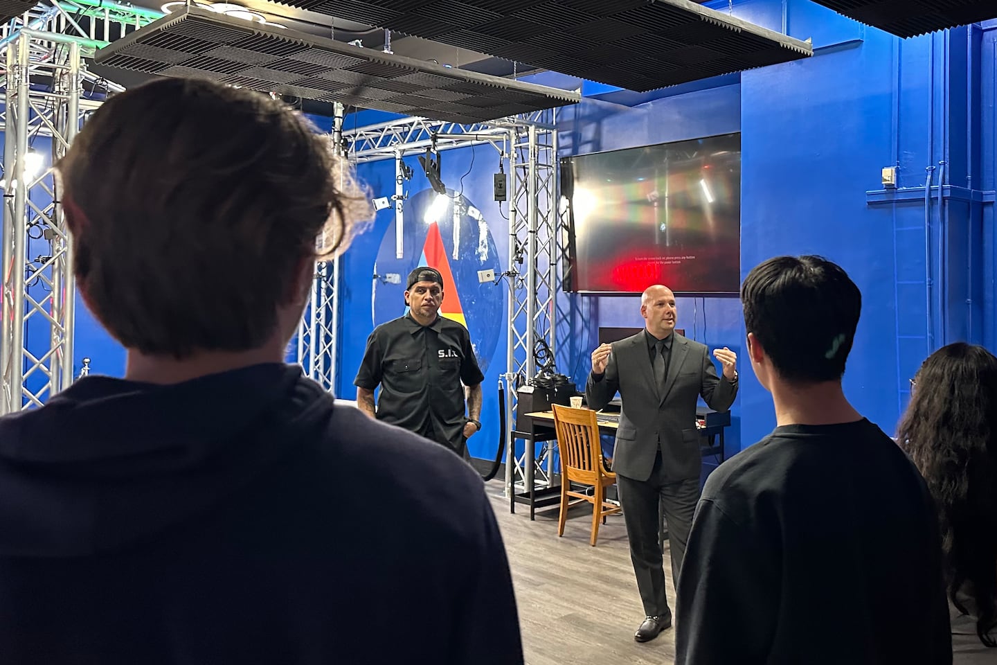 Media entrepreneur Hezues Scott and Principal Gregory Bowen show students at Ralph R. McKee Career and Technical Education High School in Staten Island a new studio that aims to help them with mental health issues. (Trenton Daniel / Healthbeat)