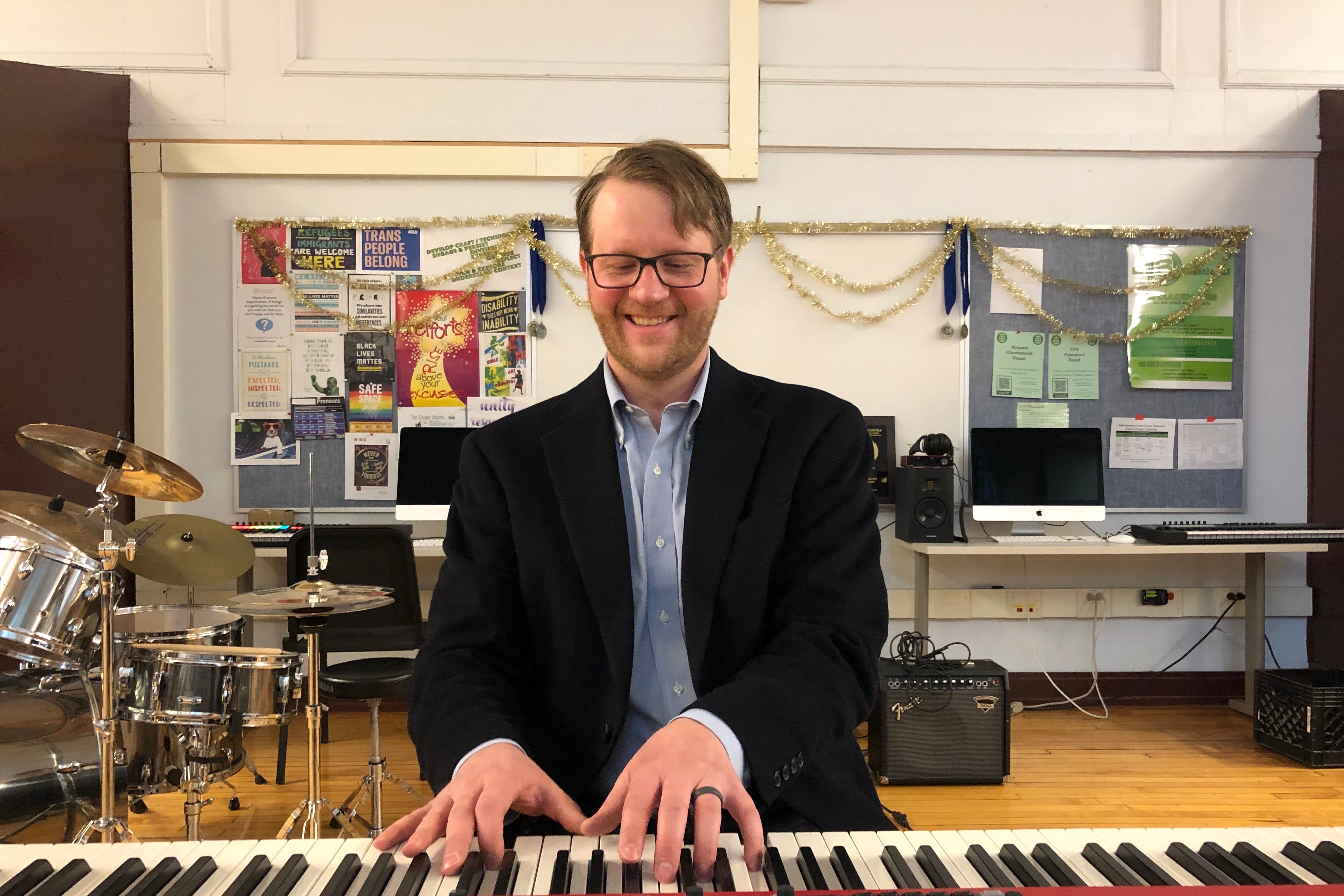 A man plays a keyboard inside a high school classroom on Chicago’s North Side.