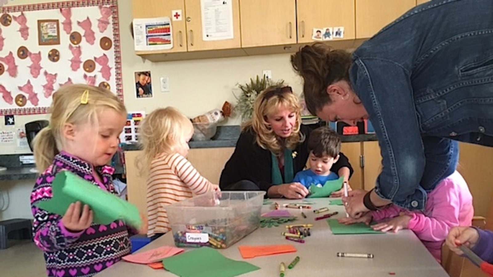 Pam Sturgeon, an early childhood mental health consultant, works with a boy at TLC Learning Center in Longmont.