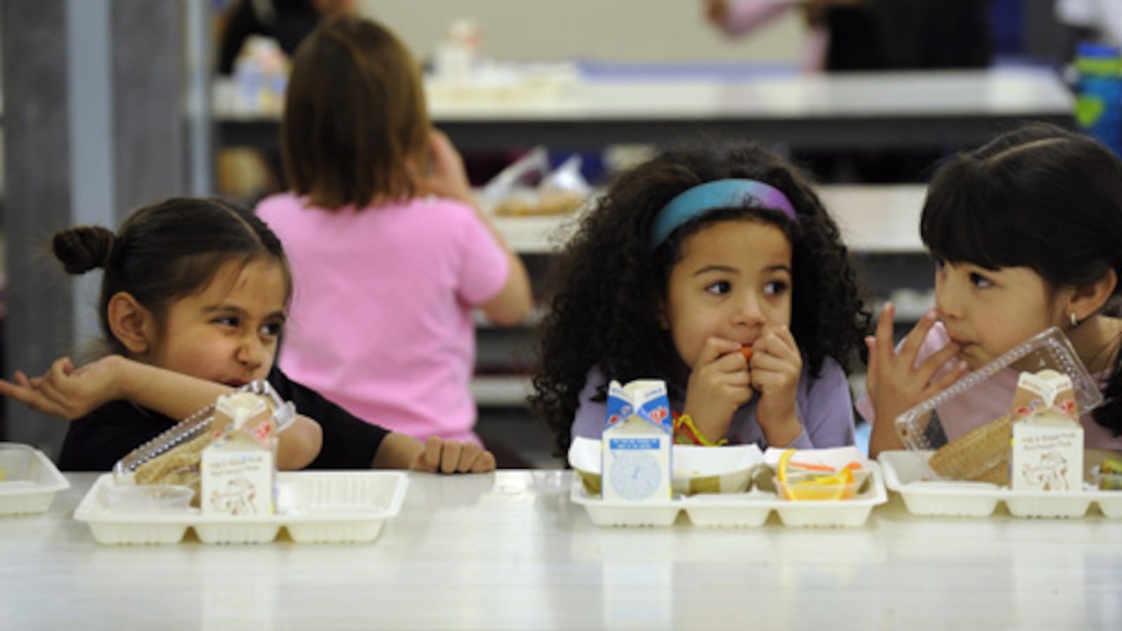 Students eat lunch in the cafeteria at Dora Moore K-8 School in Denver.