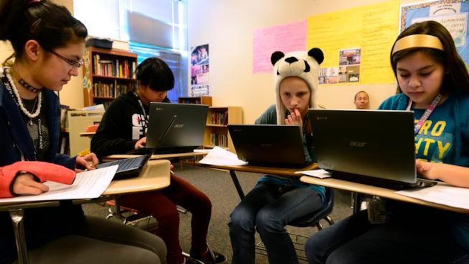 Dulcinea Sorrell, 14, Kenia Castro, 14, Rachel Ross, 13, and Victoria Pasillas, 13, use Chromebooks to prepare for state tests in a language arts class at Aurora's Columbia Middle School.
