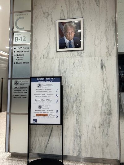 A photograph of a photo of President Donald Trump hands on a stone wall.