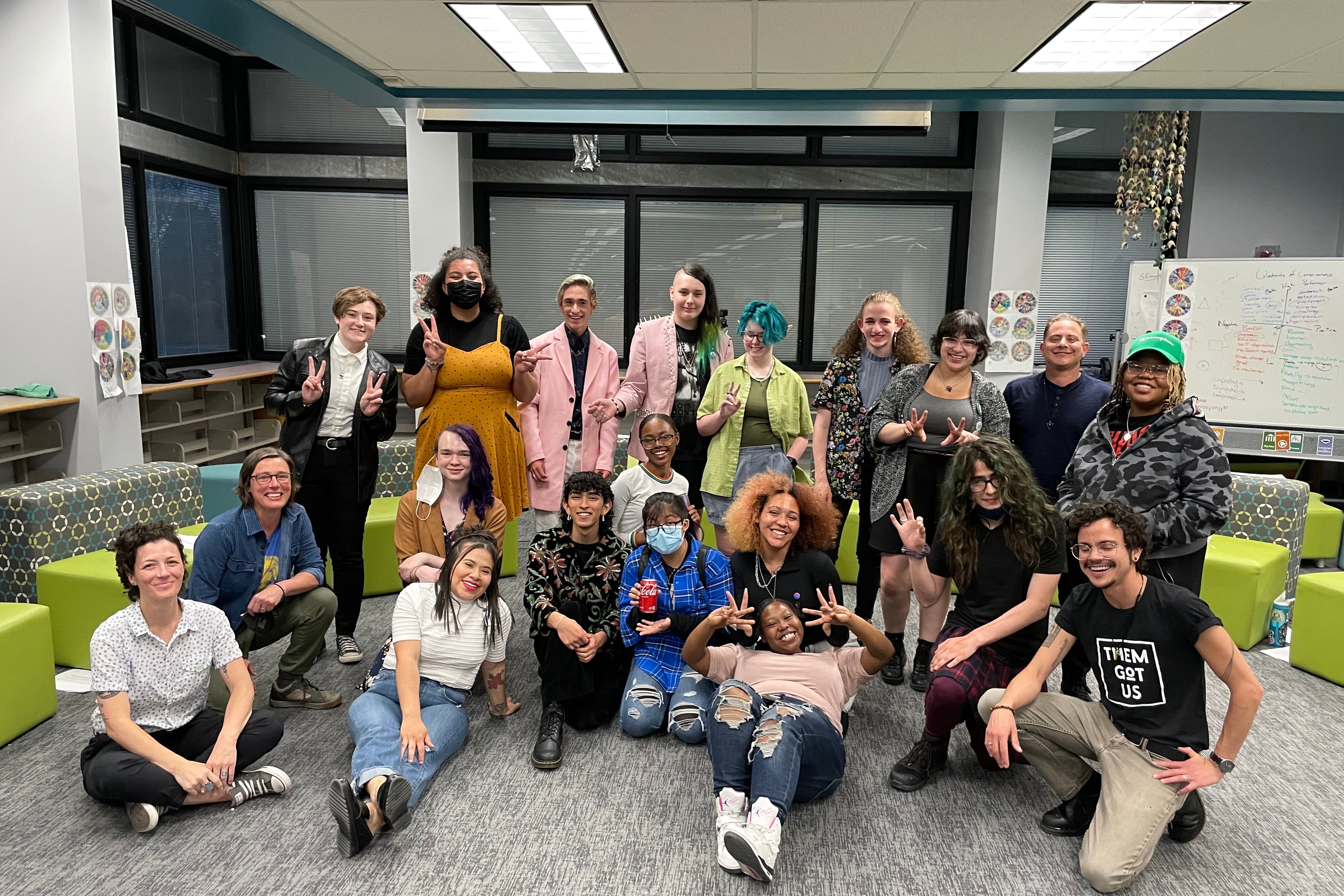 A group of students pose in a library.