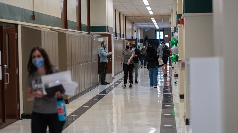 Staff and students walk the halls of Senn High School on the first week back to classrooms on April 23, 2021.