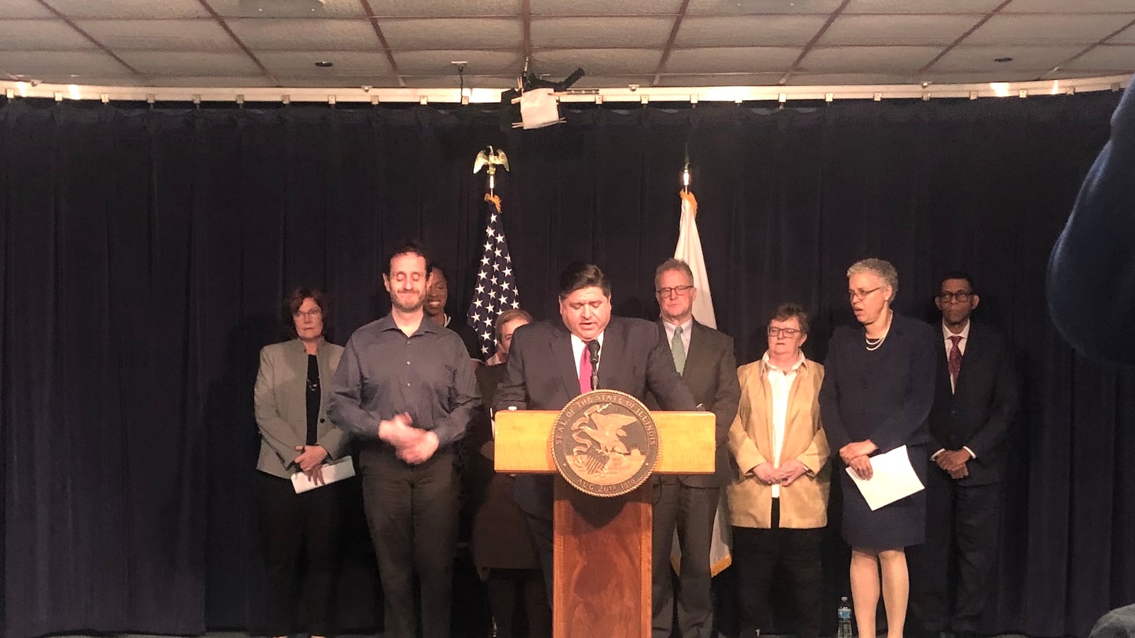 Gov. J.B. Pritzker stands with city and county officials as he announces four new coronavirus cases on Mar. 9. 2020.