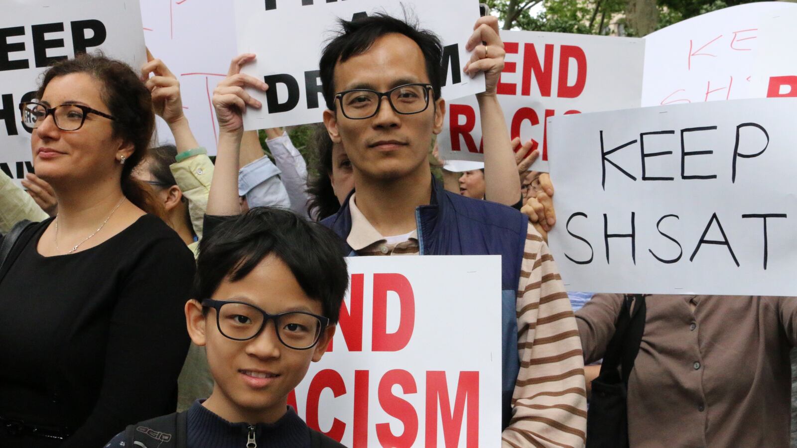Davis Zong Jr, a sixth-grade student at the selective school New Explorations into Science, Technology and Math, and his father, Davis Zong Sr., attend a rally in 2018 to keep the SHSAT.