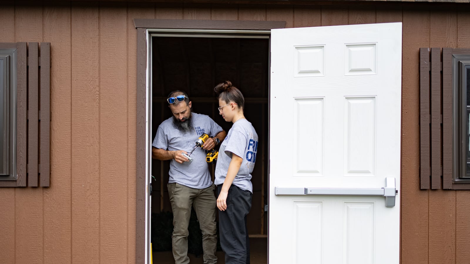 A father helps his daughter to construct an electrical outlet.