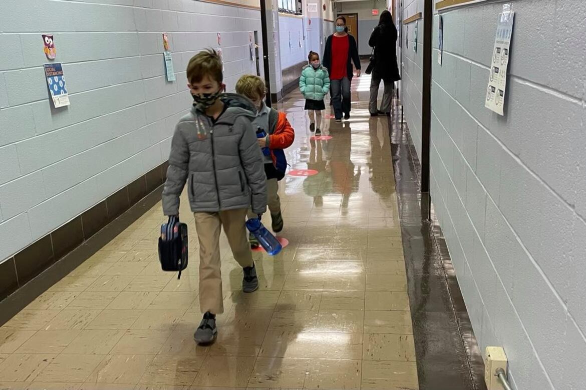 Wearing masks, kindergarten students walk back to their classroom after taking a restroom break at Chester Arthur Elementary School in South Philadelphia.