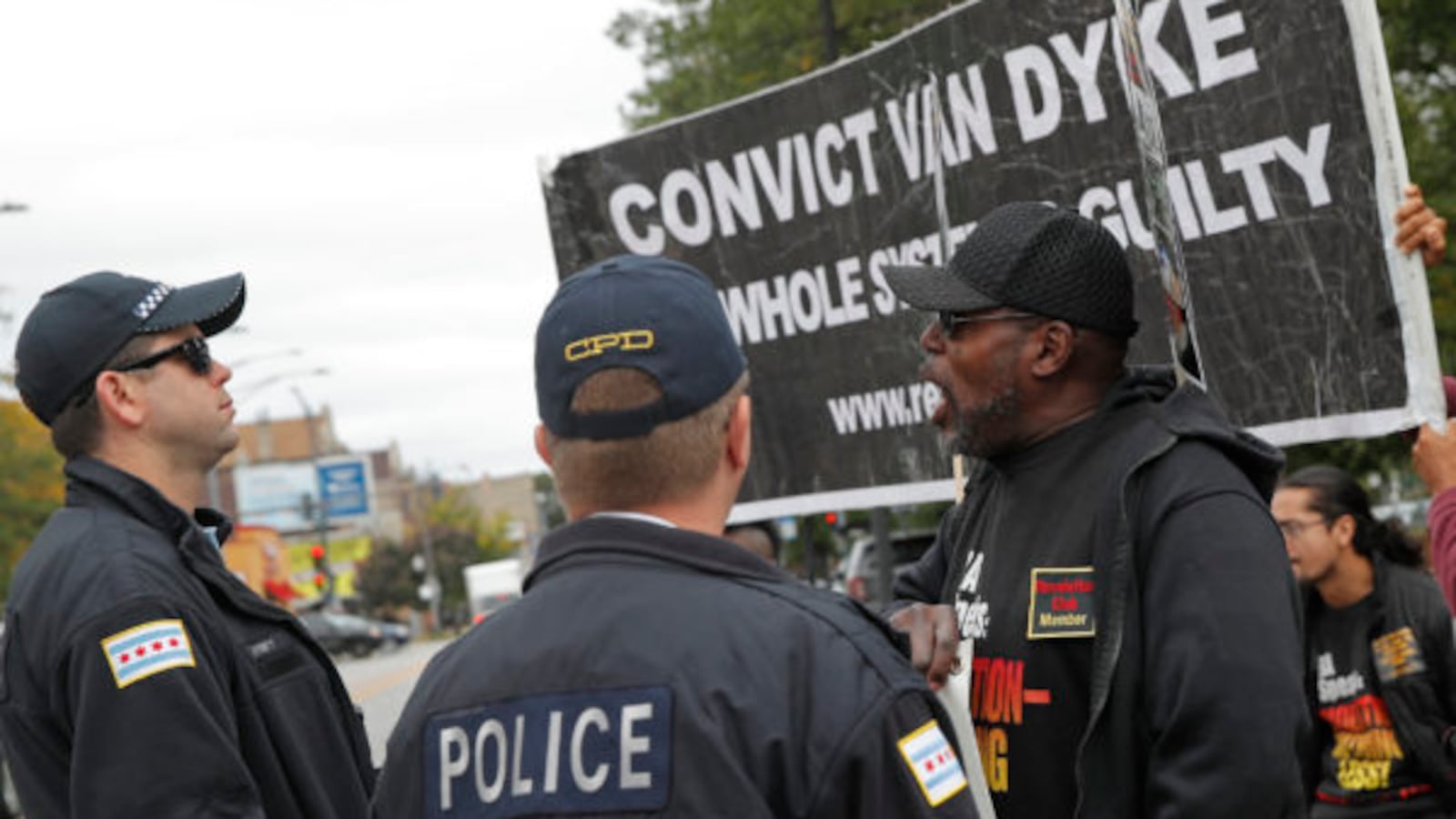 Protesters calling for the conviction of Chicago police officer Jason Van Dyke demonstrate in front of a line of Chicago police officers outside the Leighton Criminal Court Building in Chicago, October 4, 2018. - Van Dyke is charged with killing 17-year-old Laquan McDonald 16 times in an October 2014 confrontation.