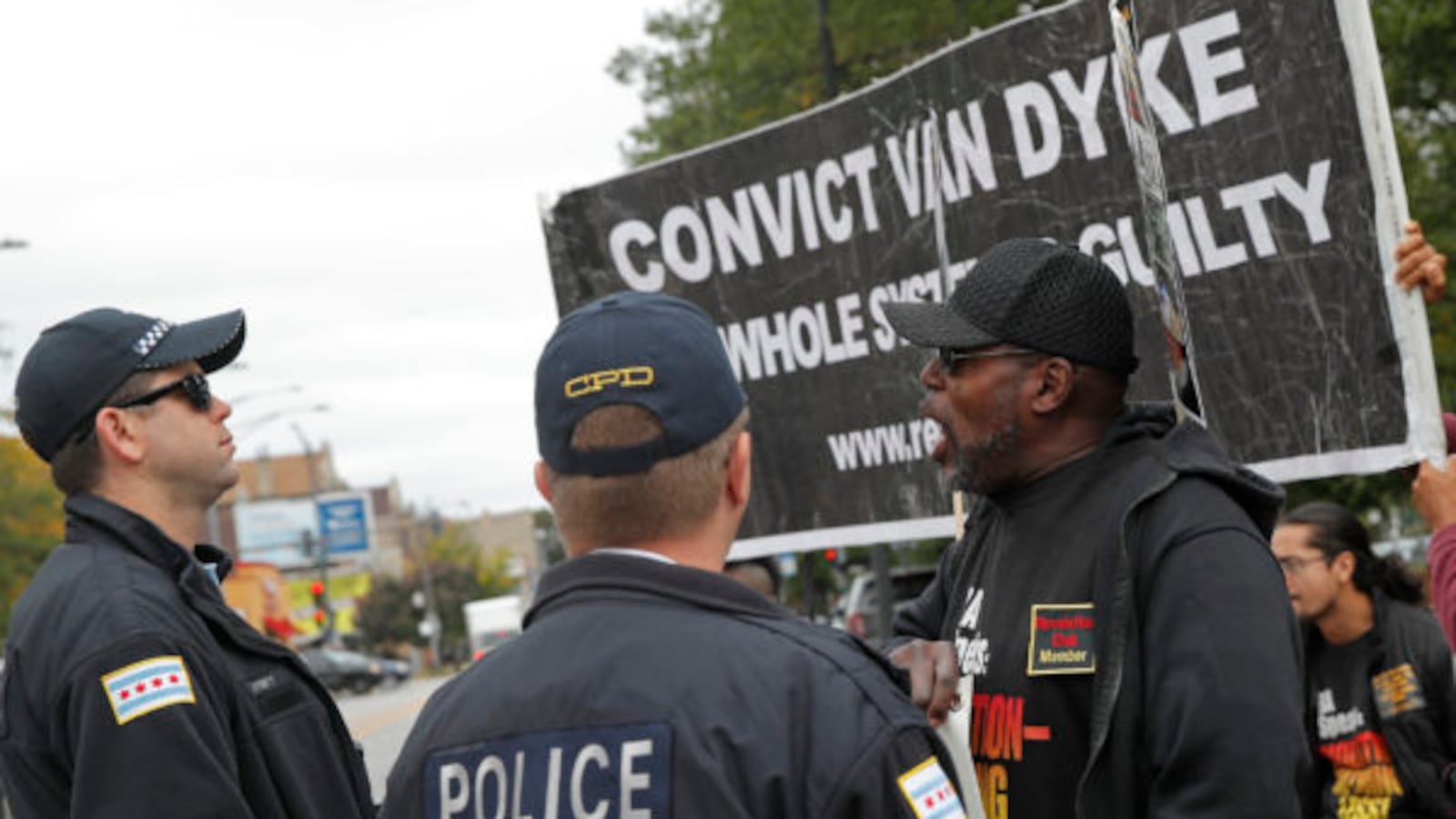 Protesters calling for the conviction of Chicago police officer Jason Van Dyke demonstrate in front of a line of Chicago police officers outside the Leighton Criminal Court Building in Chicago, October 4, 2018. - Van Dyke is charged with killing 17-year-old Laquan McDonald 16 times in an October 2014 confrontation.