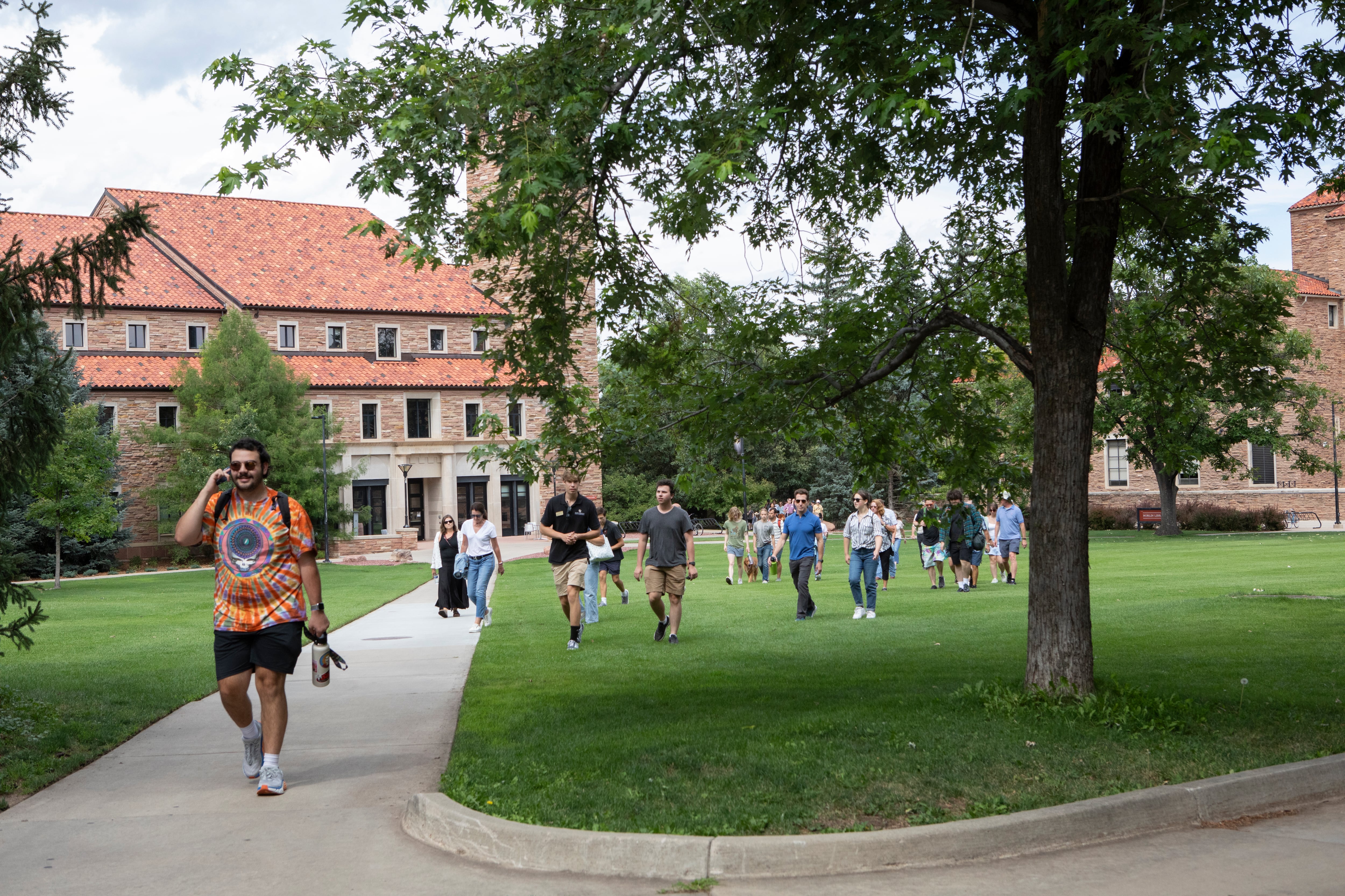 Students walk around a college campus.