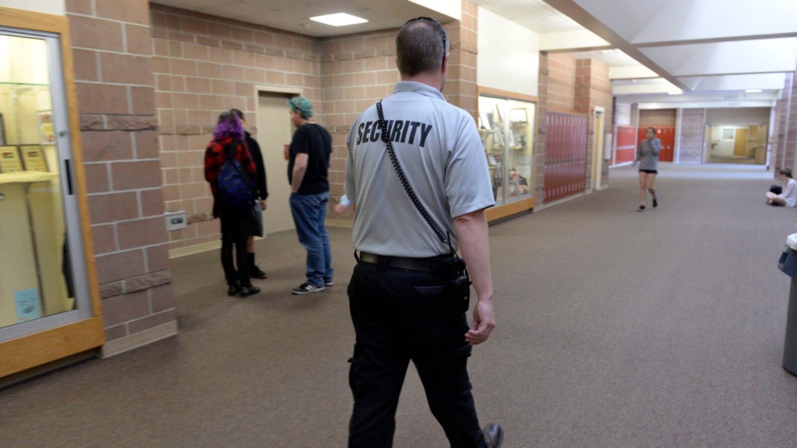 Douglas County School District security officer Ian Scott patrols the halls and checks in with students at Rock Canyon High School in 2017. (Photo by Kathryn Scott/The Denver Post via Getty Images)