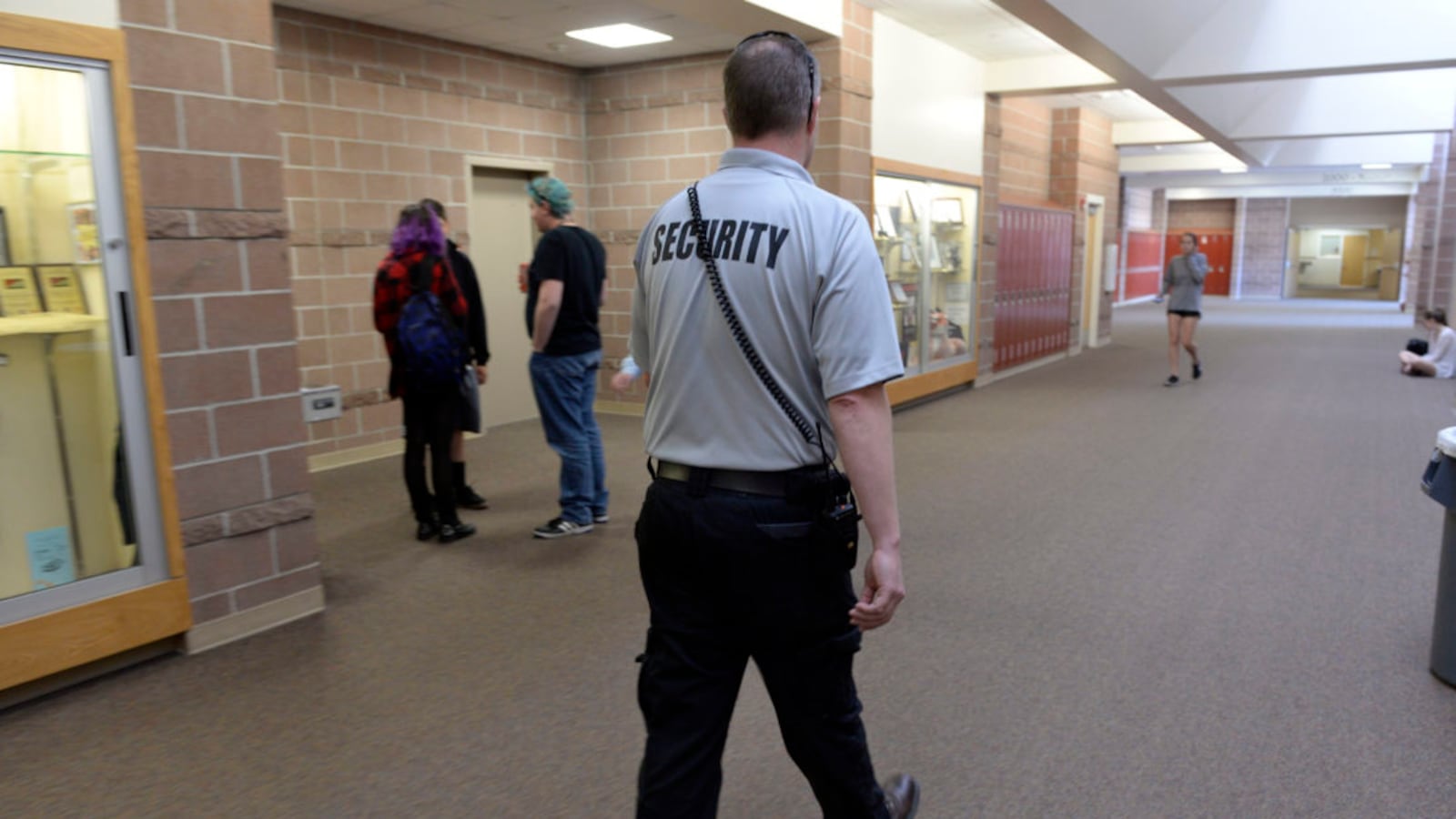 Douglas County School District security officer Ian Scott patrols the halls and checks in with students at Rock Canyon High School in 2017. (Photo by Kathryn Scott/The Denver Post via Getty Images)