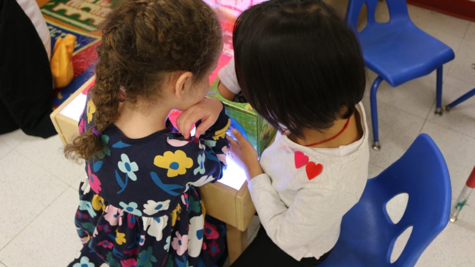 Pre-K students play at a light table at The Renaissance Charter School in Jackson Heights.