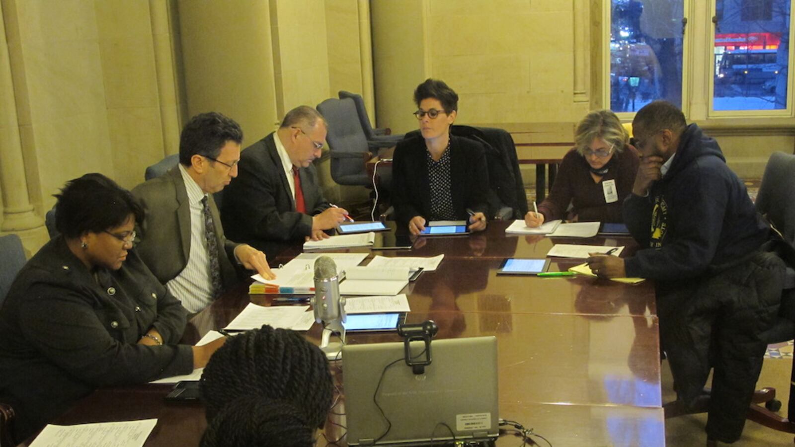 Counterclockwise from the right, Panel for Educational Policy members Robert Powell, Deborah Dillingham, Lori Podvesker, and Isaac Carmignani, at a contracts meeting with city education officials David Ross and Courtney Jackson Chase.