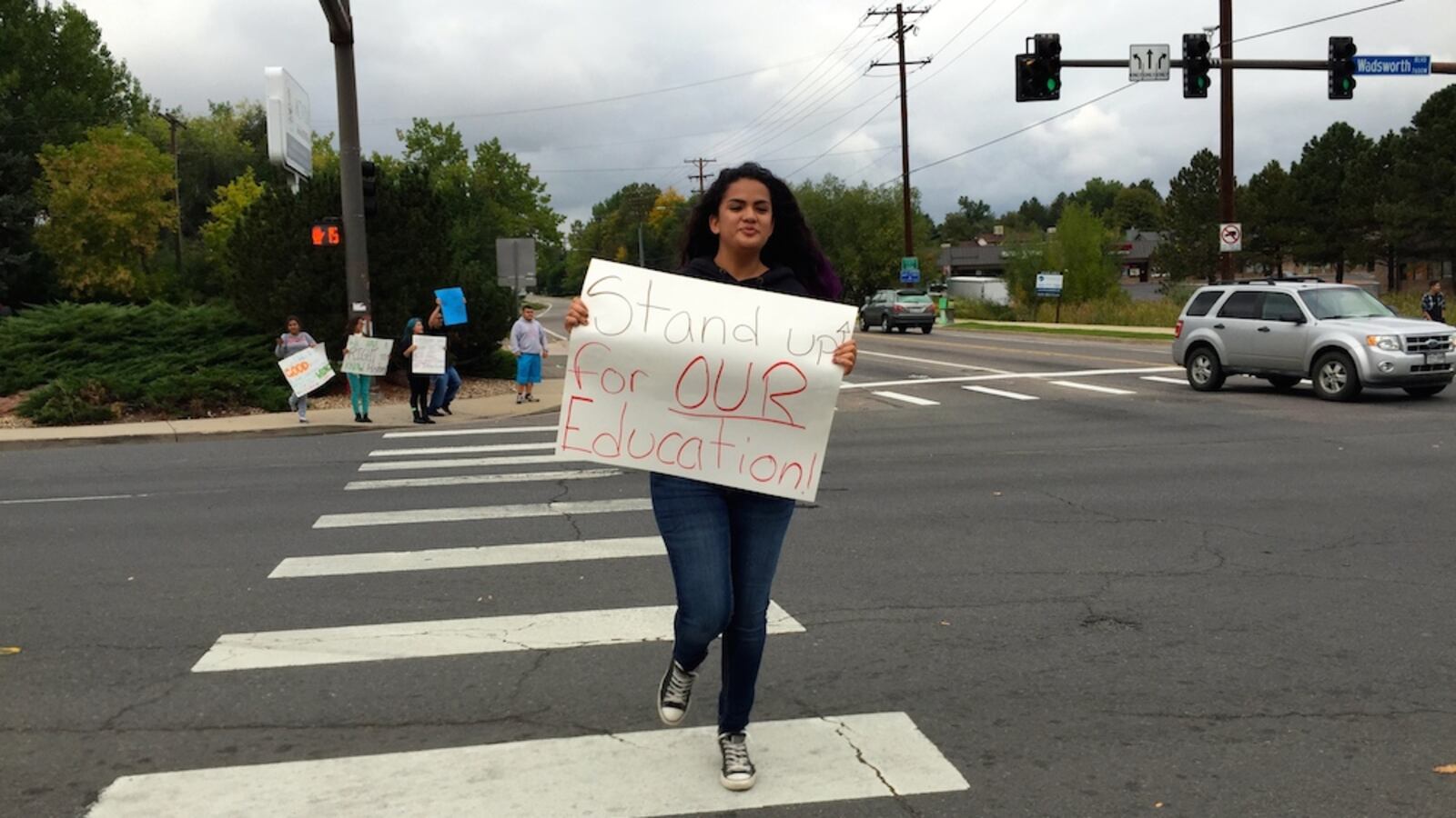 A Jefferson High School student skipped across Wadsworth Boulevard Monday during a student-organized protest. Jefferson High was the last Jeffco neighborhood high school to demonstrate against a proposed curriculum review committee they believe would lead to censorship.