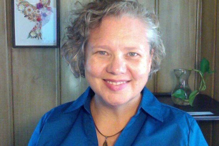 A woman around starting at the camera and occasionally