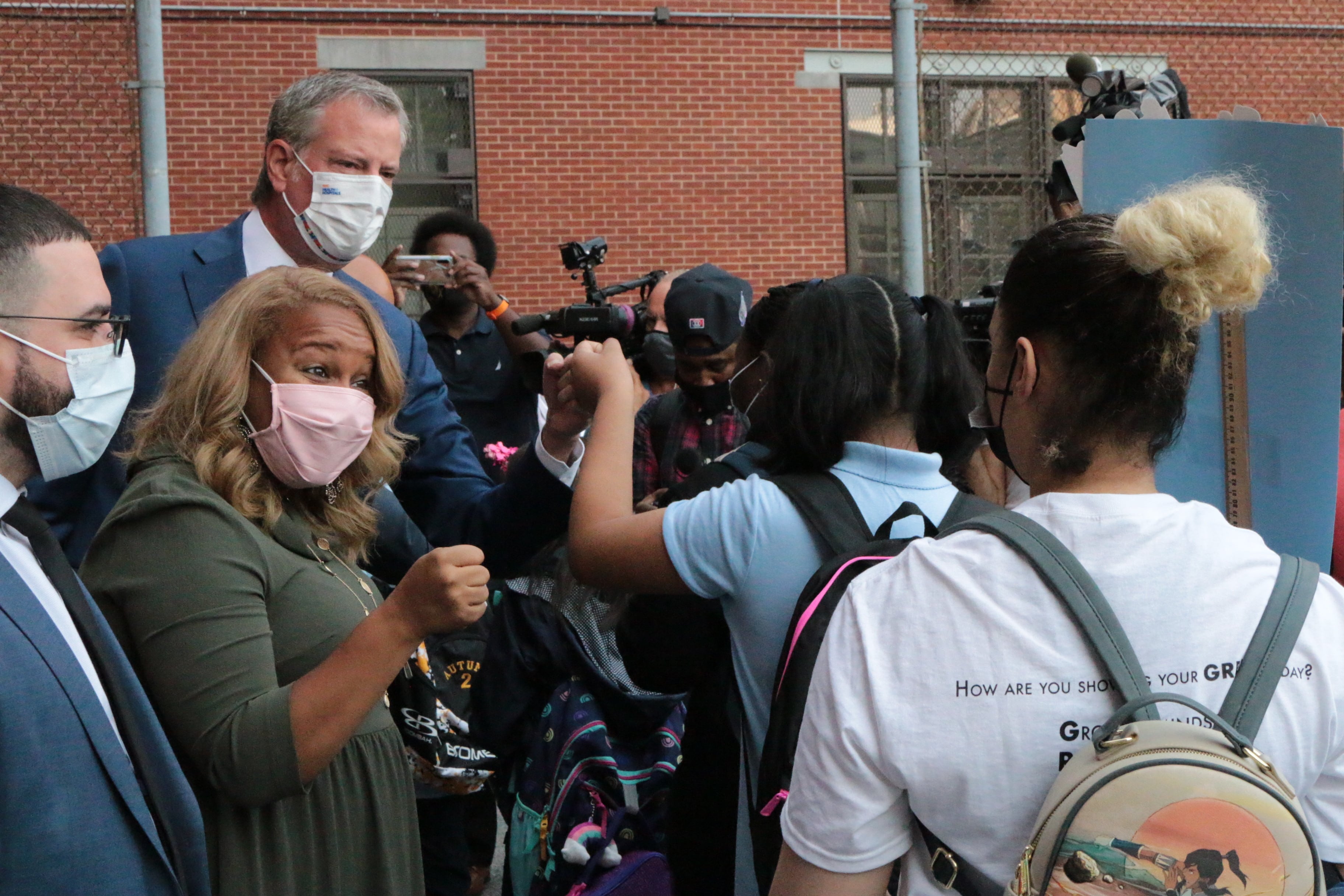 Mayor Bill de Blasio and Chancellor Meisha Porter greet parents and students on the first day of school at P.S. 25 in the Bronx.