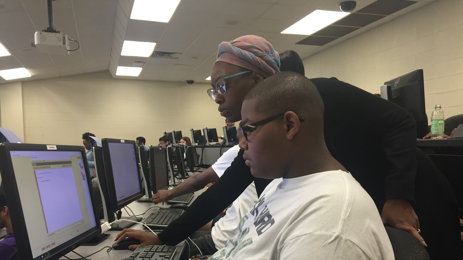 Joshua Williams, a student at Central High School, learns about coding with the help of Terricka Muhammed, a teaching assistant at the University of Memphis.