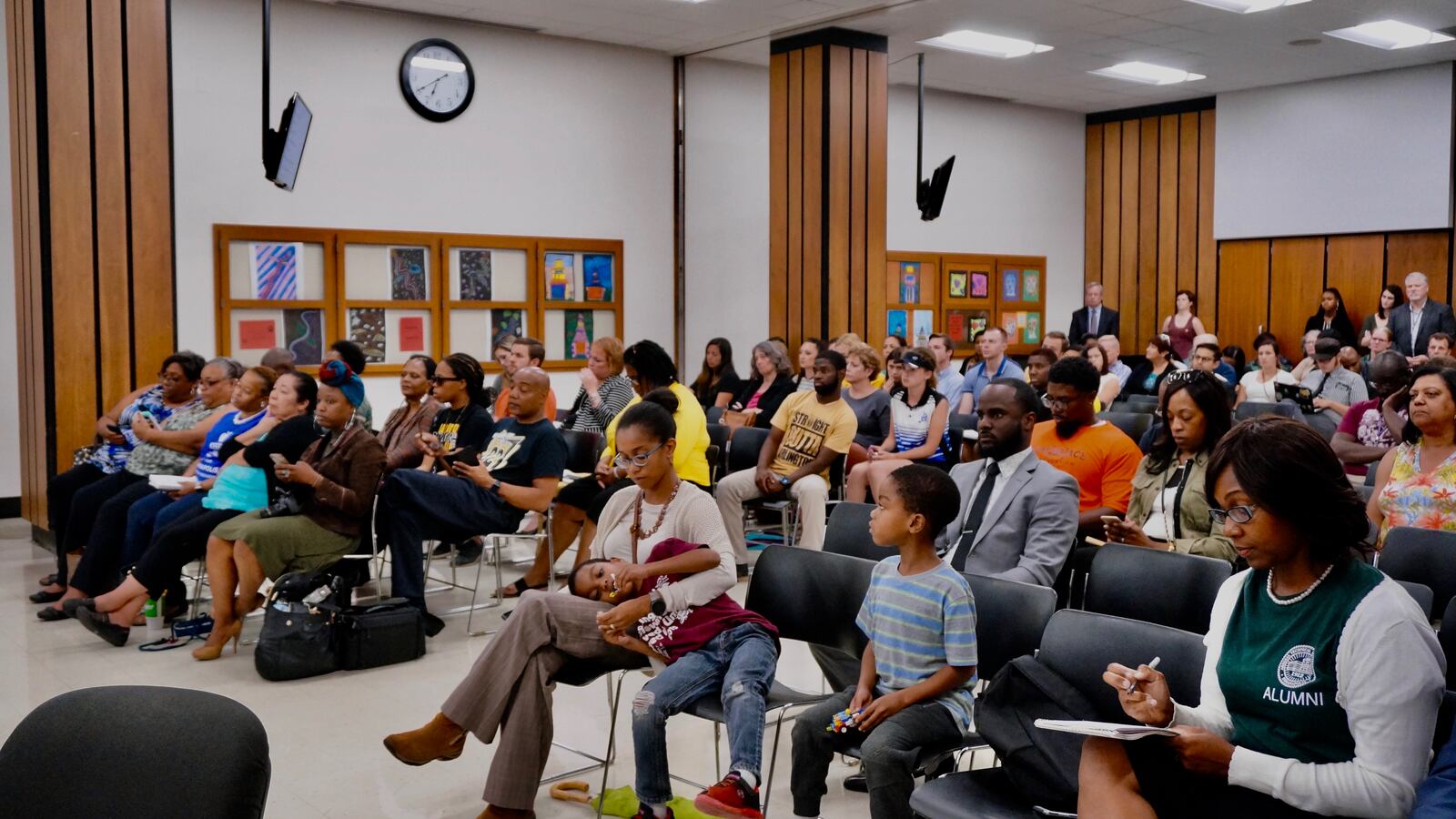 The room was crowded with parents, students and teachers as the board considered a proposal to close schools.