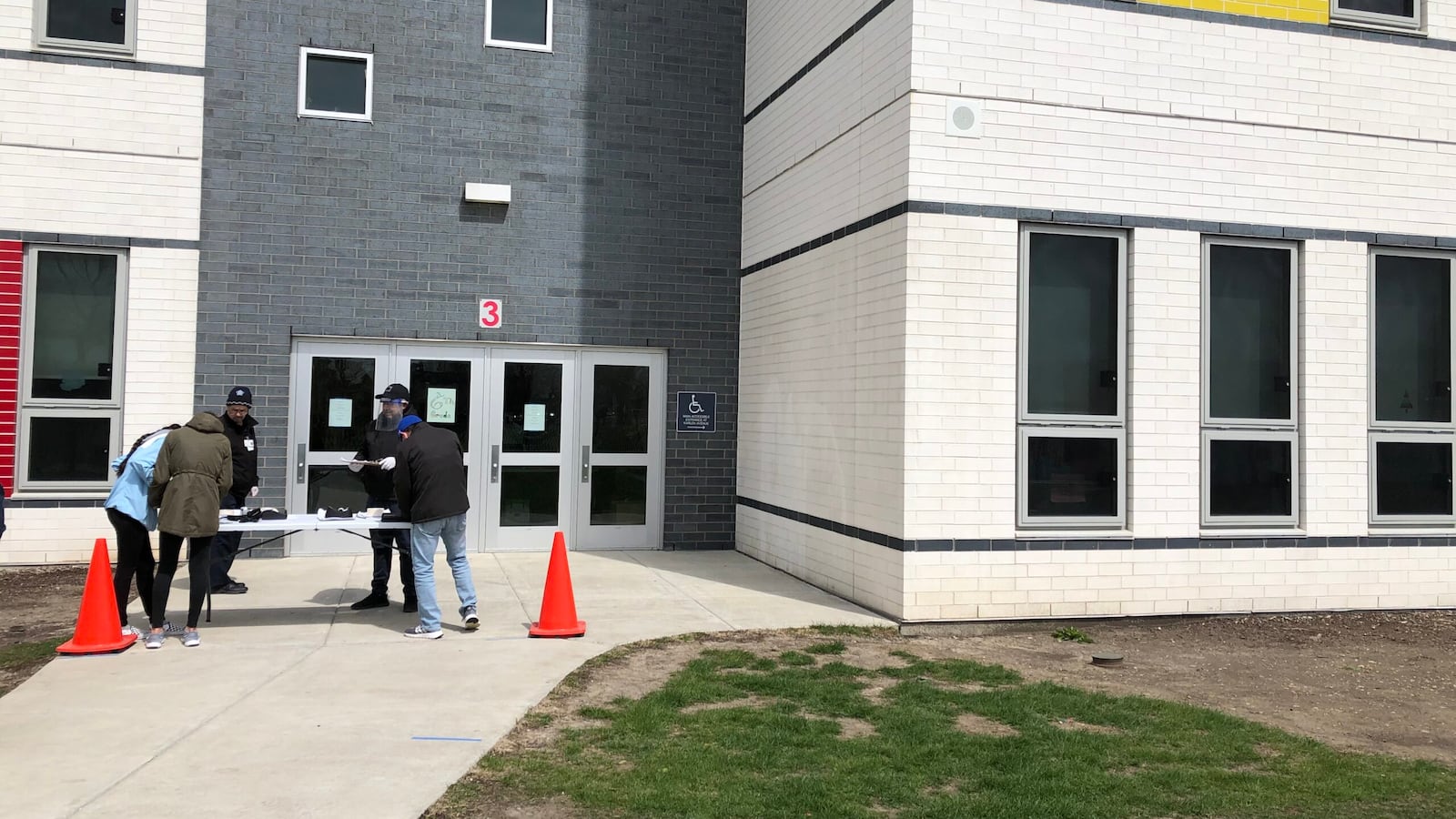 The Padilla sisters pick up loaner Chromebooks outside Richardson Middle School in Chicago on a blustery spring day.