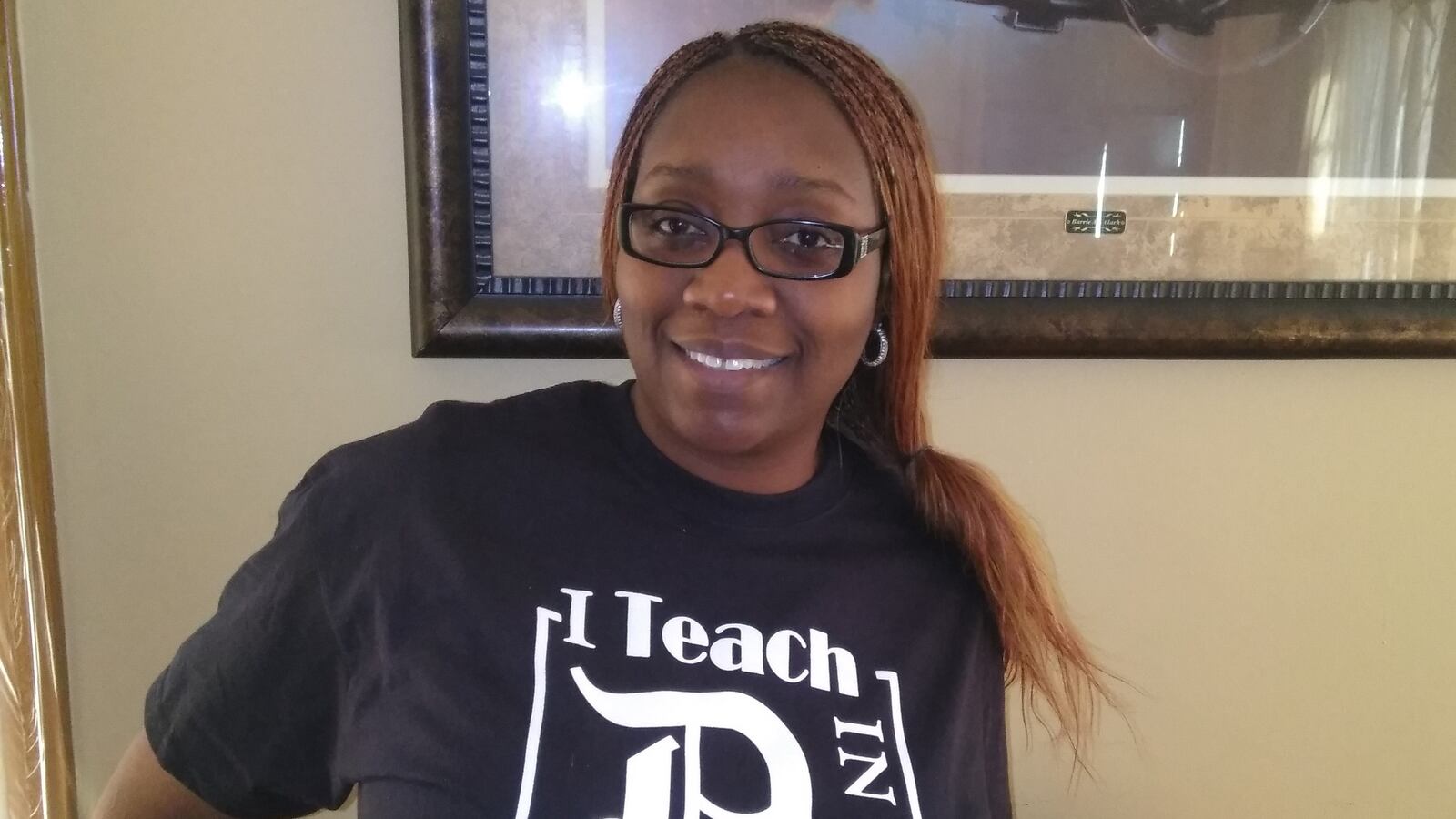 Dawn McFarlin, shown here wearing a shirt from her T-shirt company, is one of many Michigan teachers with a second job.