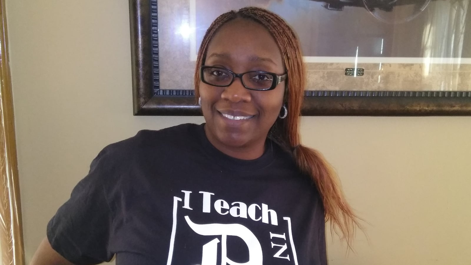 Dawn McFarlin, shown here wearing a shirt from her T-shirt company, is one of many Michigan teachers with a second job.