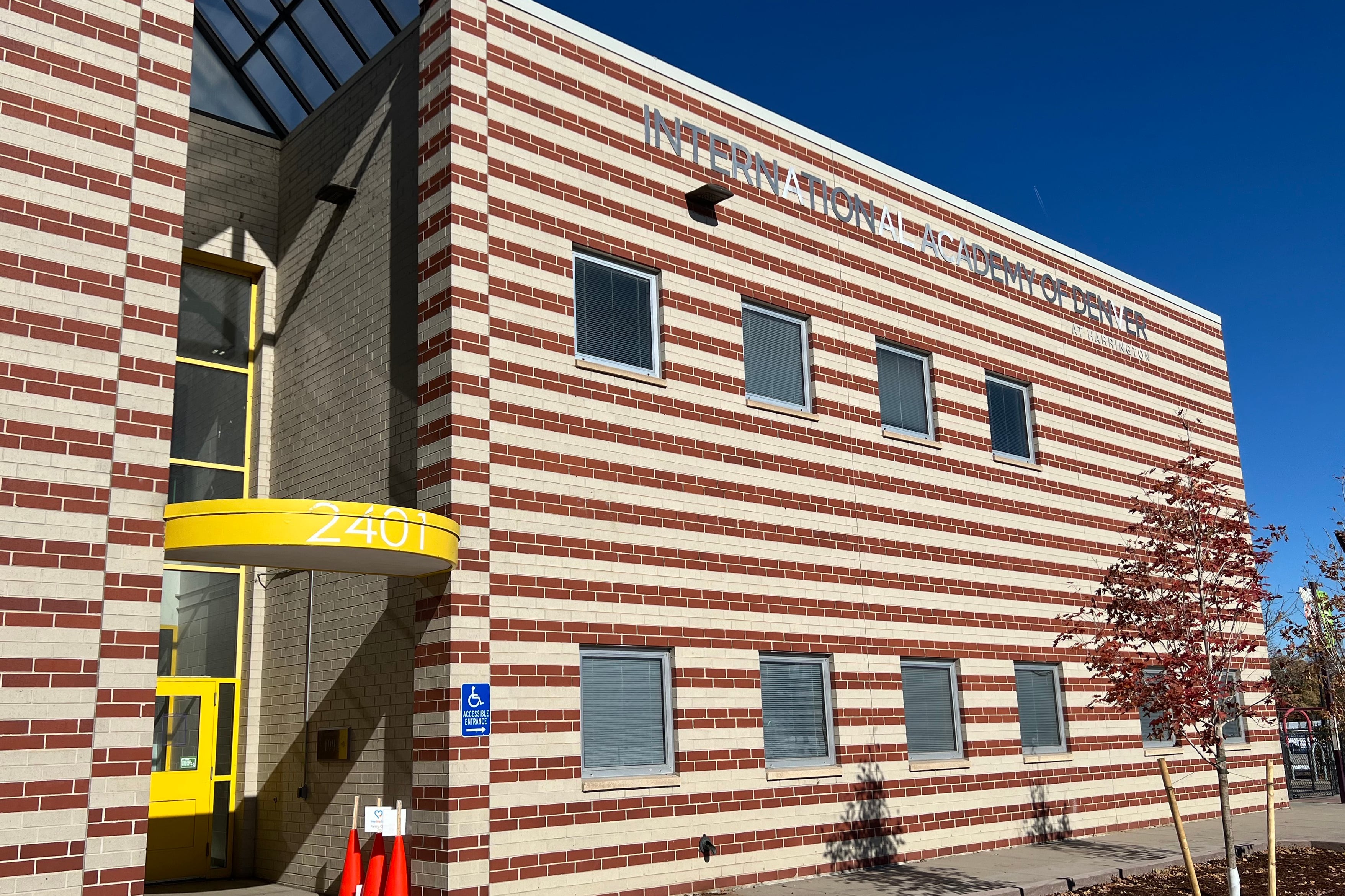 A photograph of a side of a large brick school building on a sunny day.