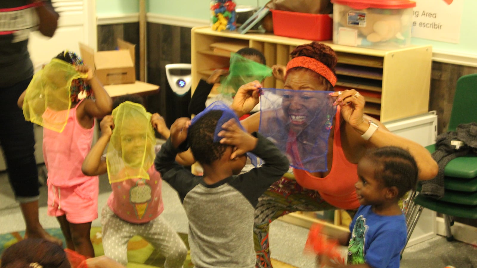 Kimberli Boyd, a working artists, teaches young children about rhymes and primary colors using scarves.
