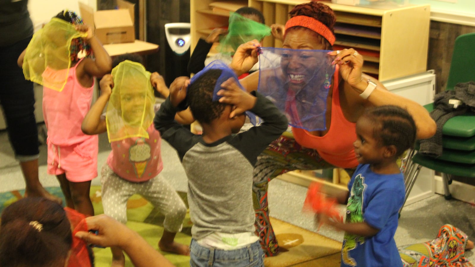 Kimberli Boyd, a working artists, teaches young children about rhymes and primary colors using scarves.