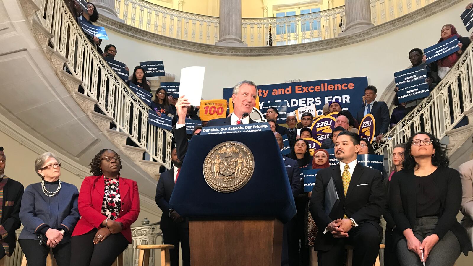 During a rally at City Hall, Mayor Bill de Blasio holds up a letter of support from labor leaders on extending mayoral control of schools.