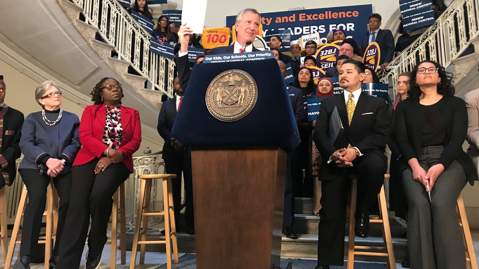 During a rally at City Hall, Mayor Bill de Blasio holds up a letter of support from labor leaders on extending mayoral control of schools.