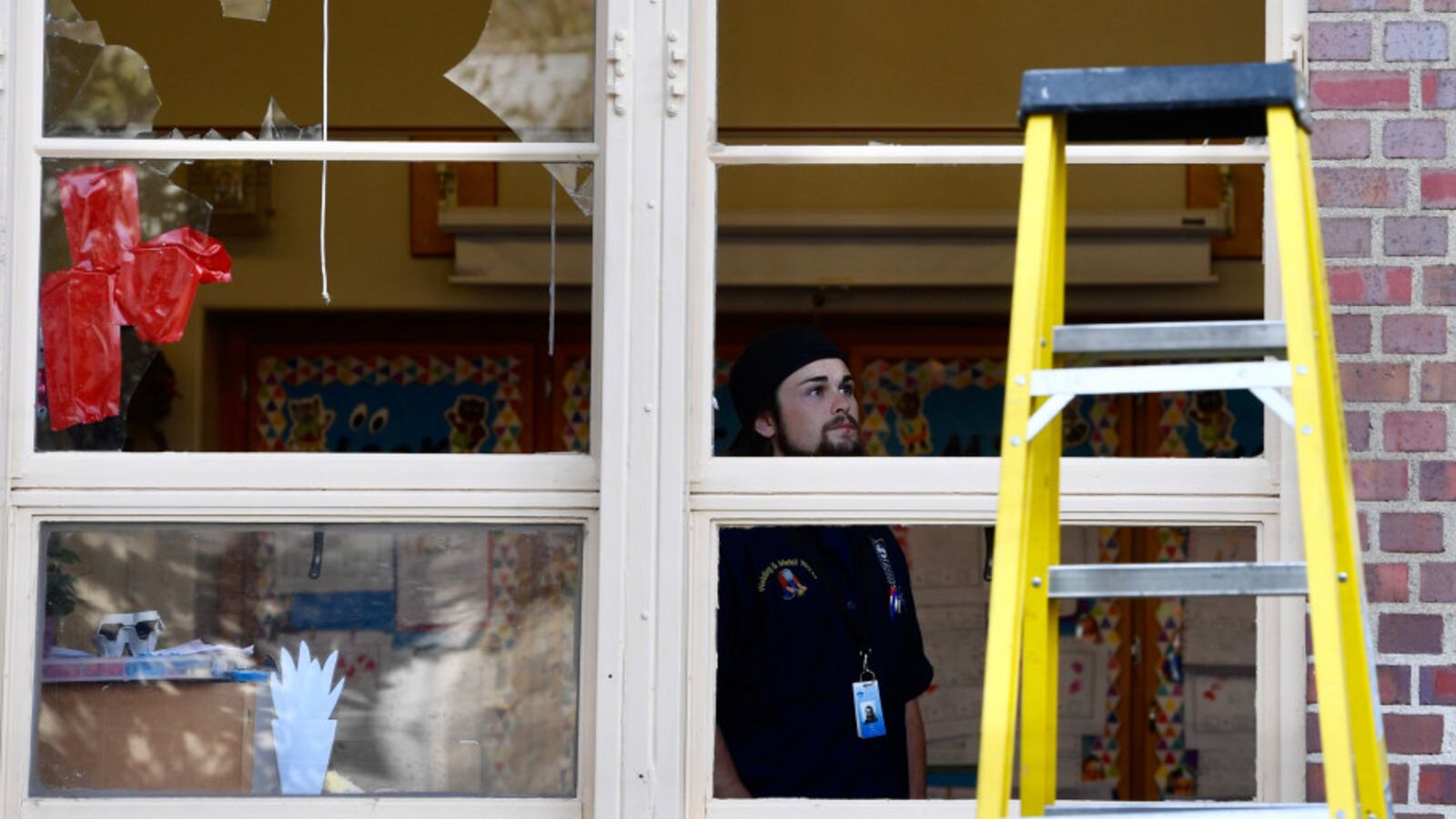 A man inspects damage inside a Denver school the morning after the severe hail storm of May 8, 2017.