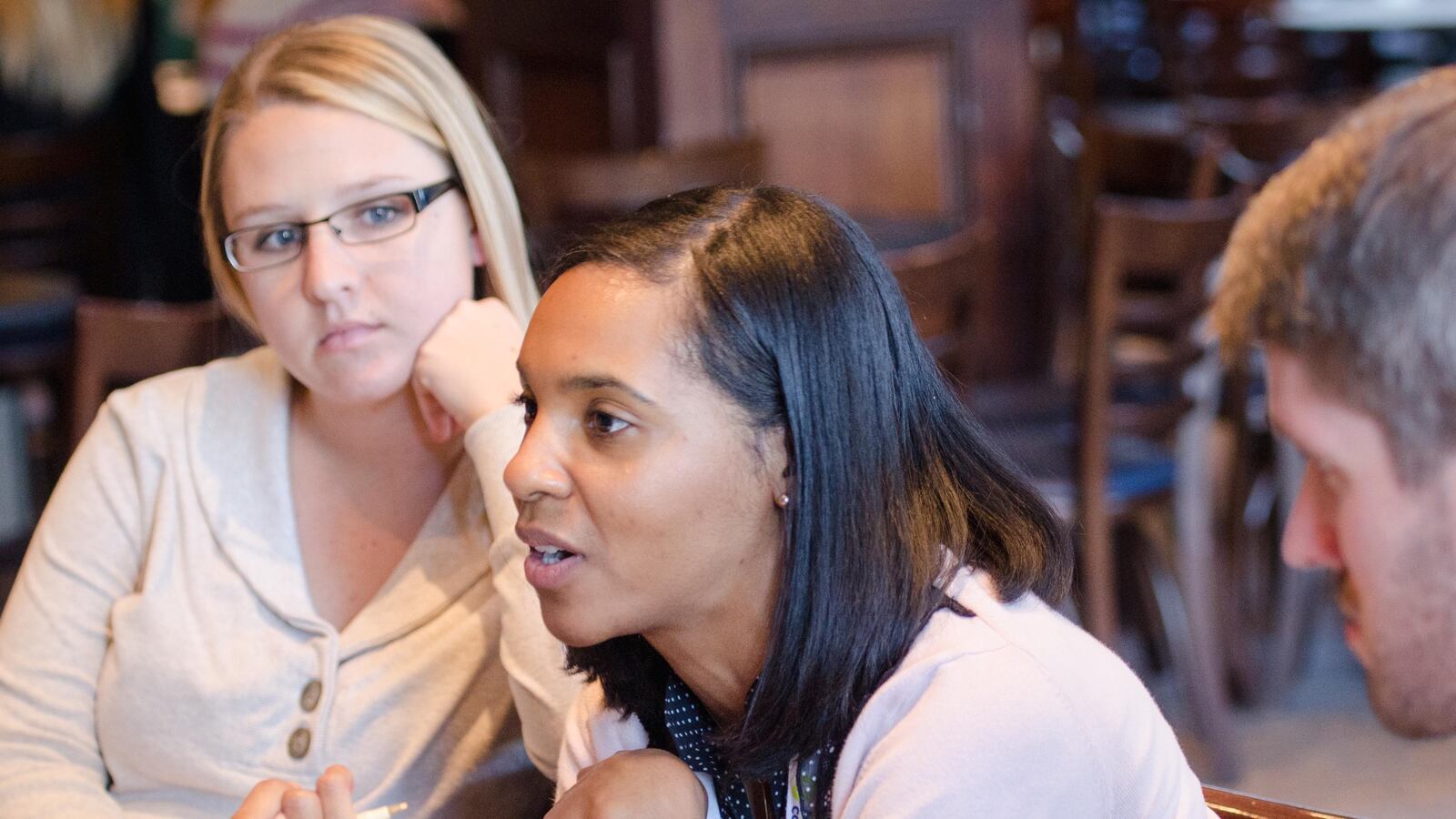 Teachers participate in discussion about recruiting teachers to low-performing schools at a T3 conference.