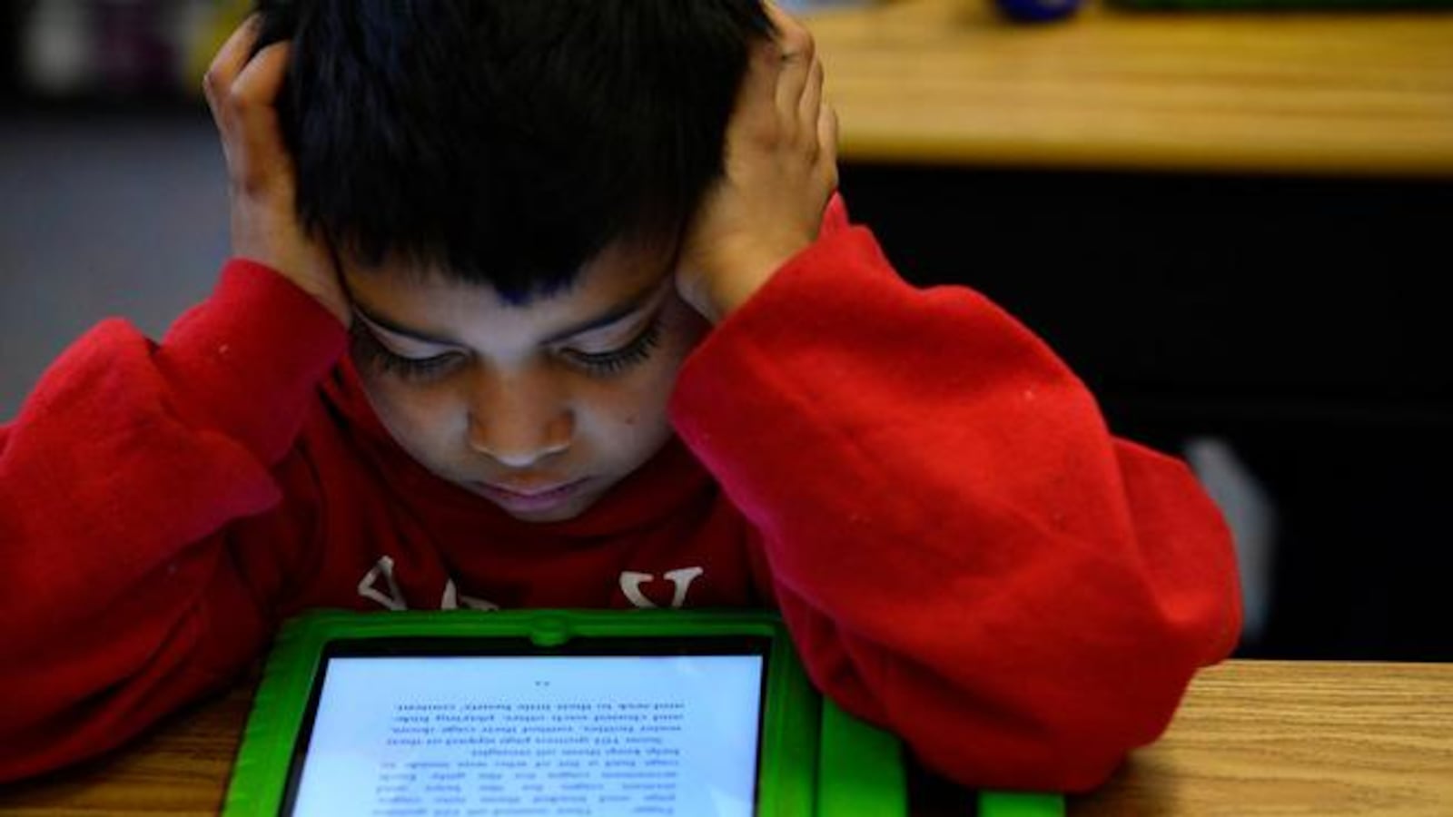 Justin Machado, 9, reads on his iPad during his 3rd grade class  at Ashley Elementary in 2015.