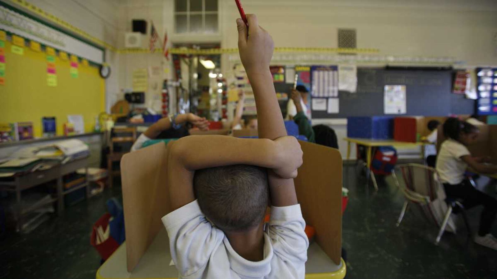 Student raising hand in class.