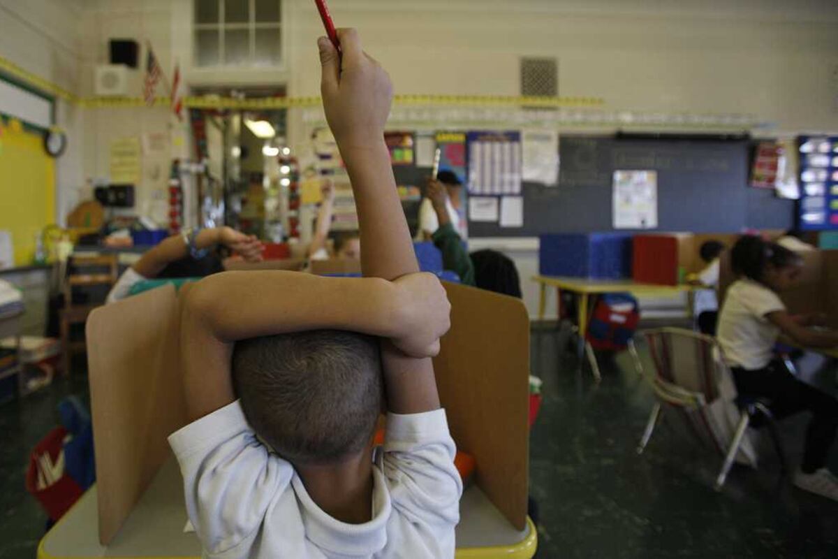Student raising hand in class.