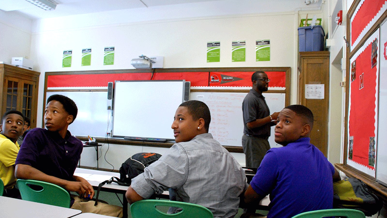 Freshmen at DSST Cole High School in Dexter Korto's morning advisory class look to the back of the class where English standards are posted.