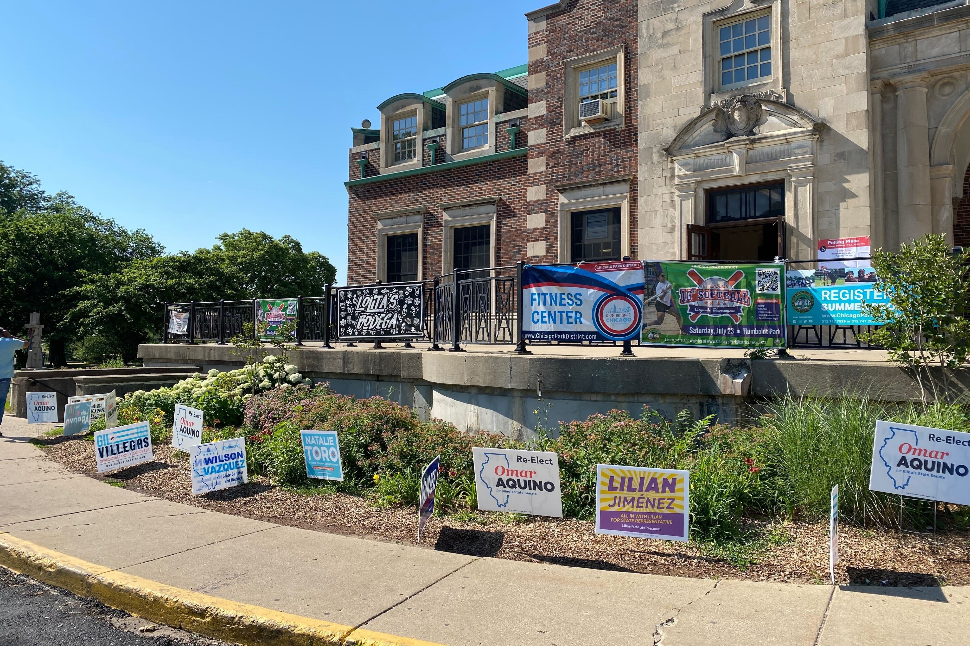 Campaign signs are posted in front of a polling station on election day.