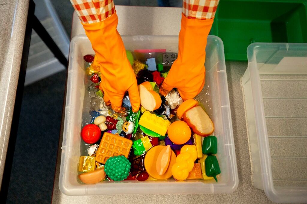 Saralyn Voltz bleaches toys in her preschool classroom at Denver’s Carson Elementary, March 13, 2020.