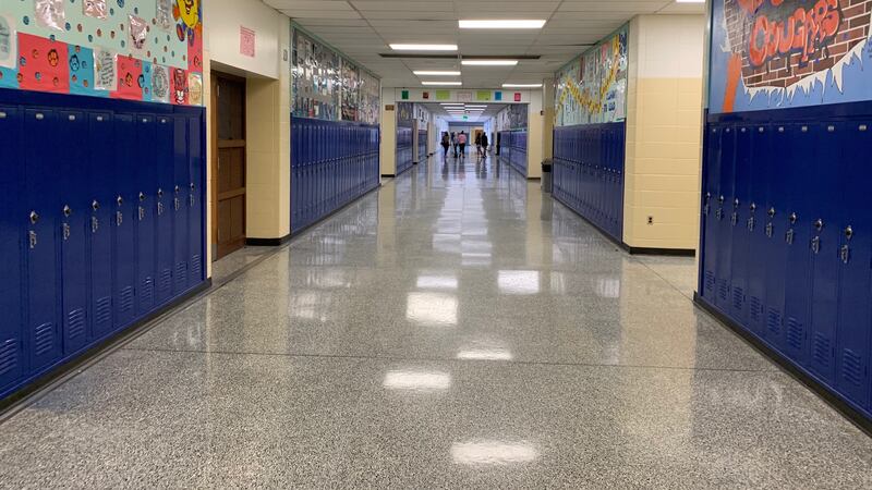 Students walk down a mostly empty hallway in Gary’s West Side Leadership Academy in December 2019.