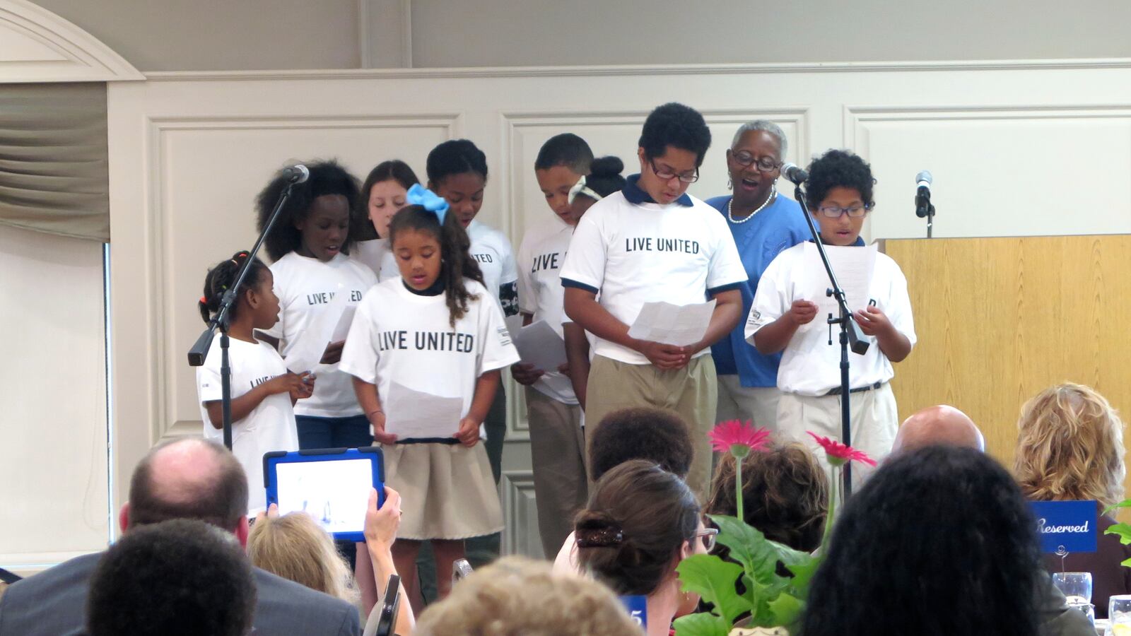 Bridges to Success coordinator Liz Odle and IPS students thank school volunteers and principals at a June celebration honoring the program.