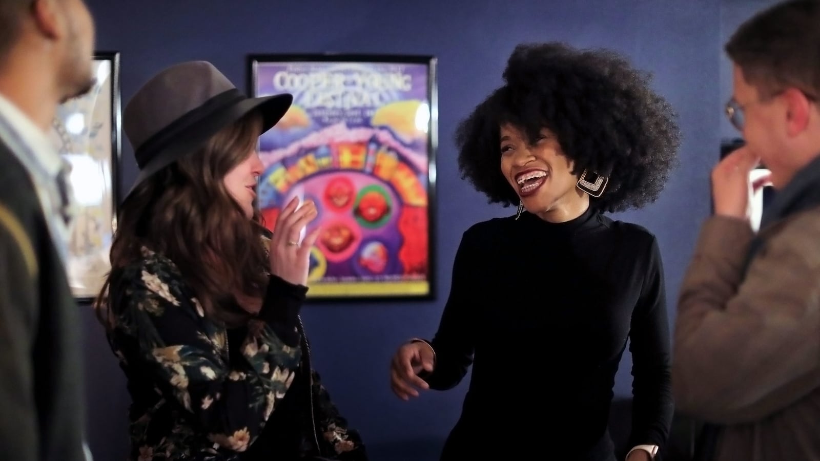 Deidra Hawkins (center right) laughs with a group of friends after a storytelling night hosted by Chalkbeat and Spillit Memphis